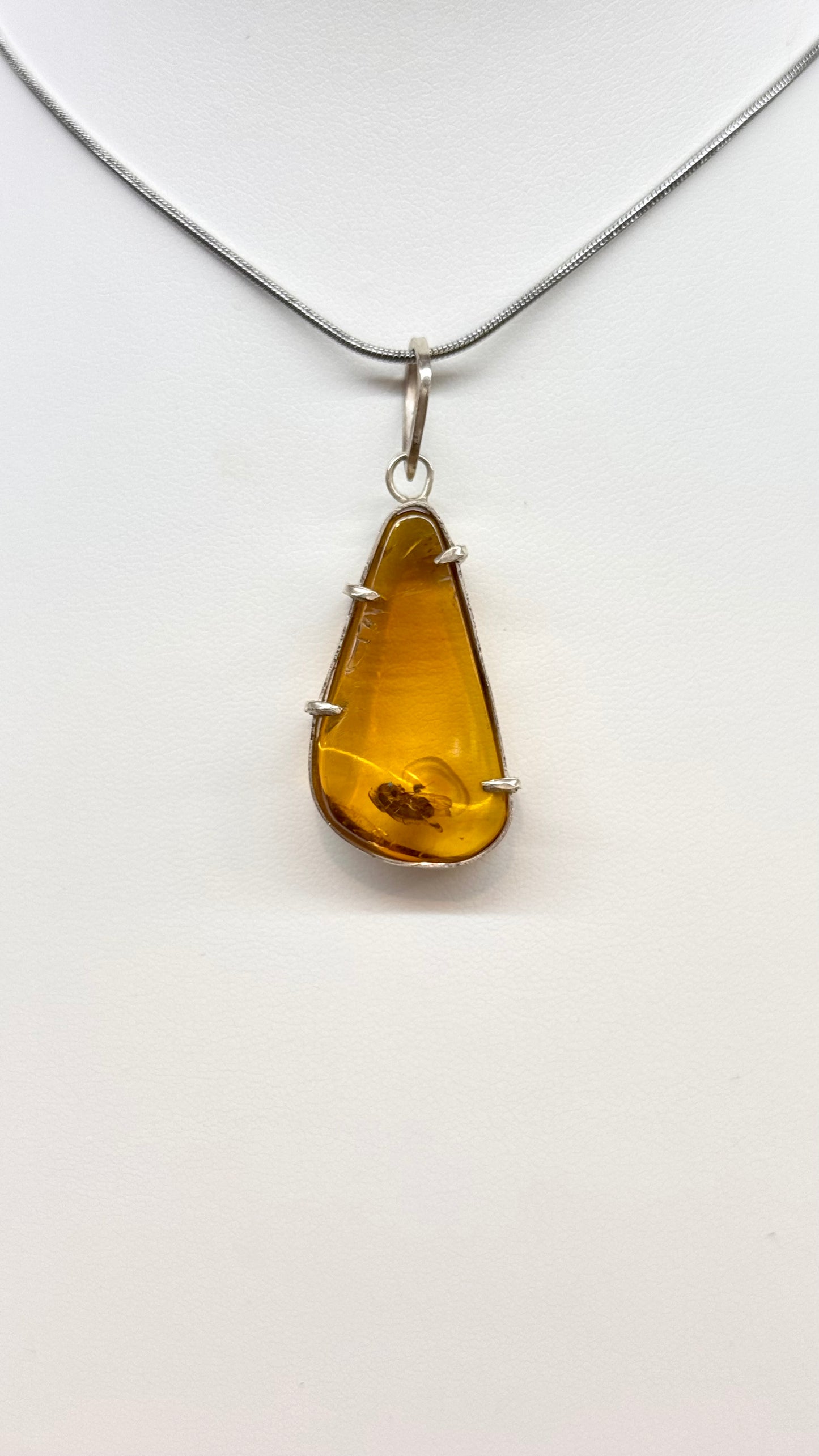 Pendentif en ambre avec mouche primitive en argent