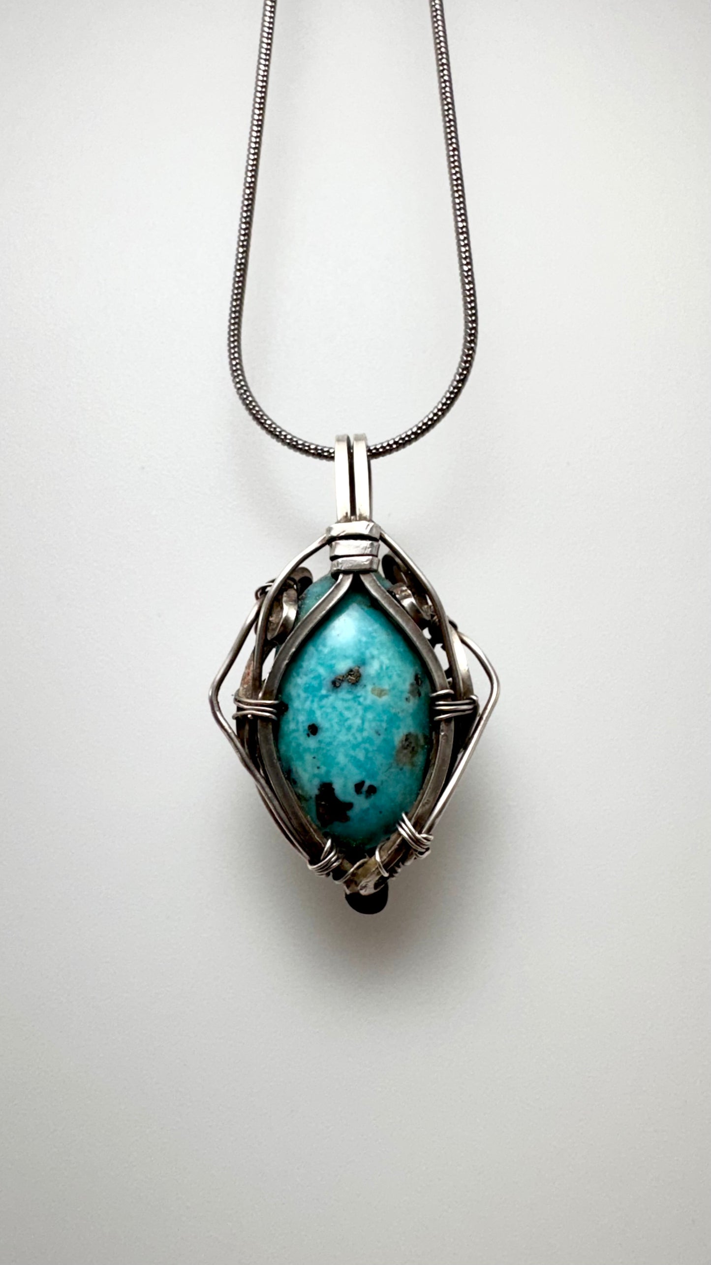 Pakistani Turquoise Pendant. Silver wire wrap.